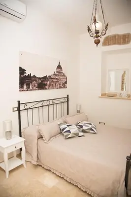 a bedroom with a bed with two pillows on it at Casa vacanza Colosseo 2 in Rome