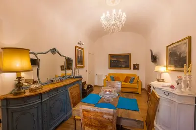a living room with a table and a couch at La Casa di Vittorio boutique Ottaviano San Pietro in Rome