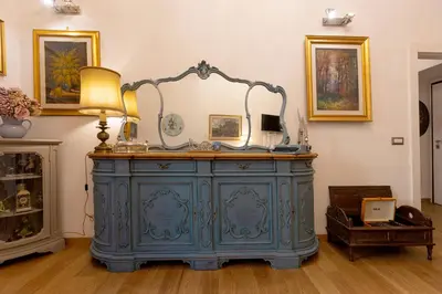 a blue dresser with a mirror on top of it at La Casa di Vittorio boutique Ottaviano San Pietro in Rome