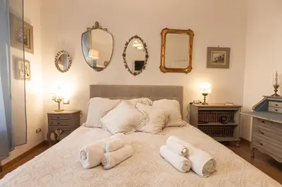 a bedroom with a large bed with towels on it at La Casa di Vittorio boutique Ottaviano San Pietro in Rome