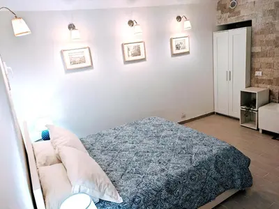 a bedroom with a bed with a blue blanket at Trastevere's Nest in Rome