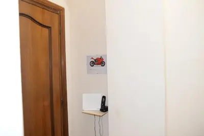 a room with a door and a phone on a wall at Emilios home Triple room in our cozy and comfortable establishment in Rome