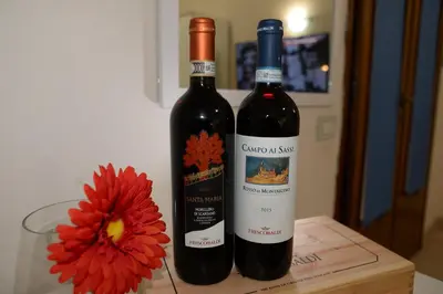 two bottles of wine on a table with a flower at Emilios home Triple room in our cozy and comfortable establishment in Rome
