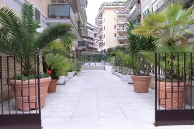 a corridor of a building with potted plants at Emilios home Triple room in our cozy and comfortable establishment in Rome