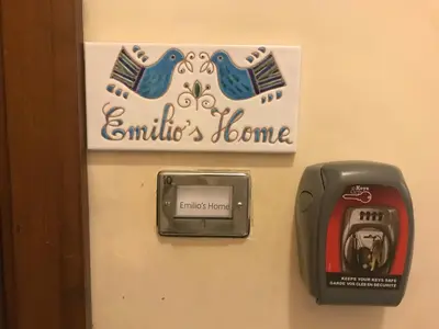 a sign on the wall of a bathroom with a pay phone at Emilios home Triple room in our cozy and comfortable establishment in Rome