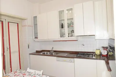 a kitchen with white cabinets and a sink at Emilios home Triple room in our cozy and comfortable establishment in Rome