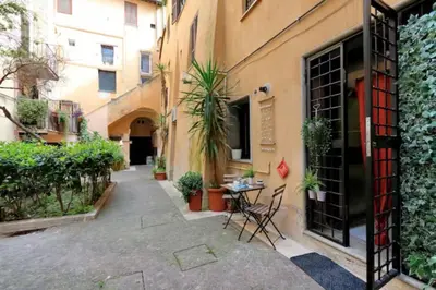 two large pots of plants sitting next to a bench at Relax Campo de' Fiori in Rome