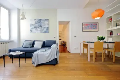 a living room with a blue couch and a table at Segneri Viale Trastevere in Rome