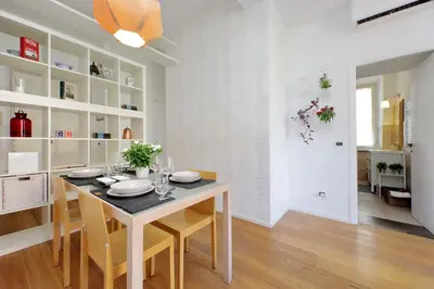 a kitchen and dining room with a table and chairs at Segneri Viale Trastevere in Rome