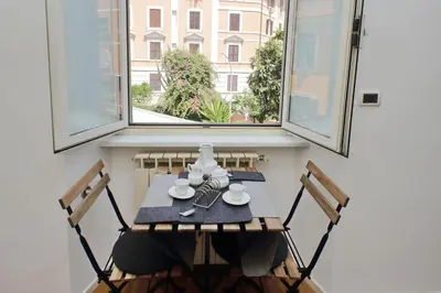 a table and chairs in a room with a window at Segneri Viale Trastevere in Rome