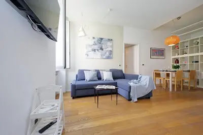 a living room with a blue couch and a table at Segneri Viale Trastevere in Rome