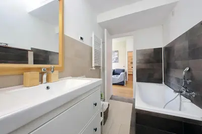 a bathroom with a white tub and a sink and a shower at Segneri Viale Trastevere in Rome