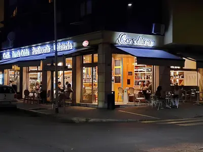 a restaurant with tables and chairs outside at night at Frank Host Roma Lux , Metro A a 50 m, simple check-in con codice a qualsiasi orario in Rome