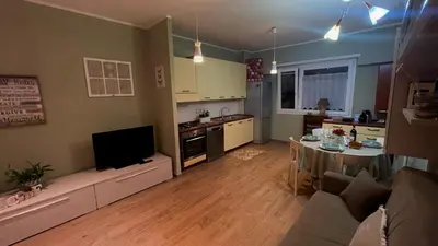 a living room with a couch and a table and a kitchen at Frank Host Roma Lux , Metro A a 50 m, simple check-in con codice a qualsiasi orario in Rome