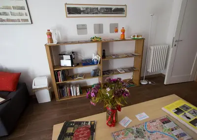 a living room with a vase of flowers on a table at Ulysses in Rome in Rome