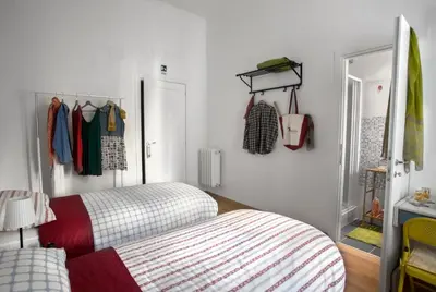 a bedroom with a bed and a closet with clothes at Ulysses in Rome in Rome