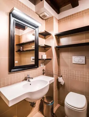 a bathroom with a sink and a toilet at Charming patio house in San Lorenzo in Rome