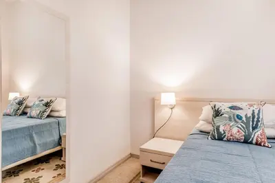 a bedroom with two beds and a mirror at APARTMENT IN TRASTEVERE in Rome