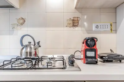 a kitchen counter with a tea kettle on a stove at APARTMENT IN TRASTEVERE in Rome