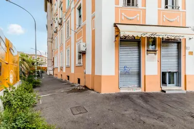 an alley with two garage doors on a building at APARTMENT IN TRASTEVERE in Rome