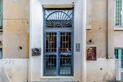 a door to a building with graffiti on it at APARTMENT IN TRASTEVERE in Rome