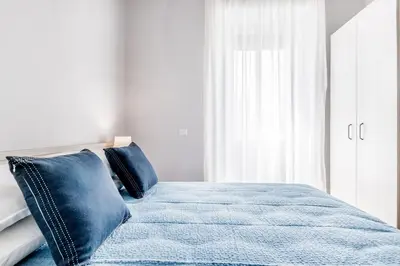 a bedroom with a blue bed with blue pillows at APARTMENT IN TRASTEVERE in Rome
