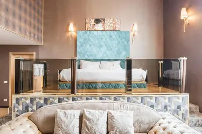 a hotel room with a bed and a couch at Penthouse Suite Rome - Private Suites in Rome