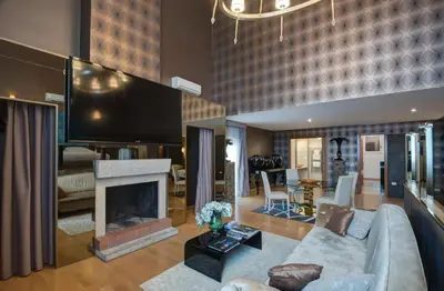 a living room with a couch and a fireplace at Penthouse Suite Rome - Private Suites in Rome
