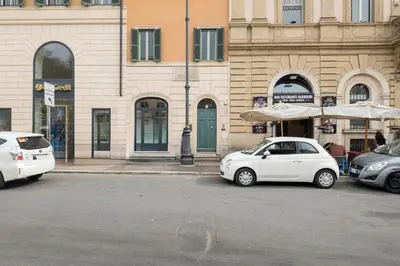 a white car parked in front of a building at Penthouse Suite Rome - Private Suites in Rome