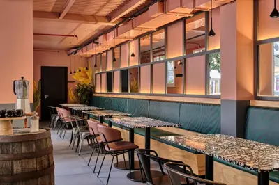 a restaurant with a table and a purple neon sign at JO&JOE ROMA in Rome