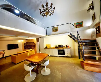 a living room with a table and a loft at Tre Colonne in Rome