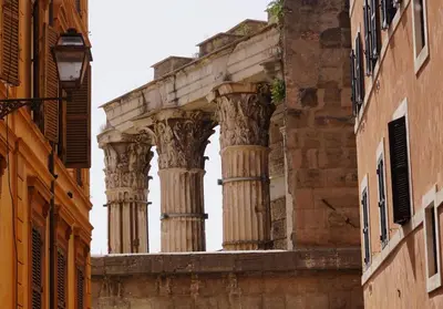 an ancient building with columns on a street at Tre Colonne in Rome