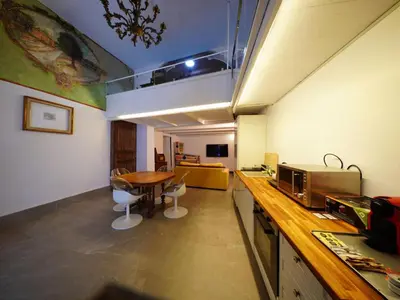 a room with a kitchen with a table and a microwave at Tre Colonne in Rome