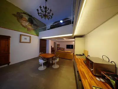 a room with a kitchen with a table and a balcony at Tre Colonne in Rome