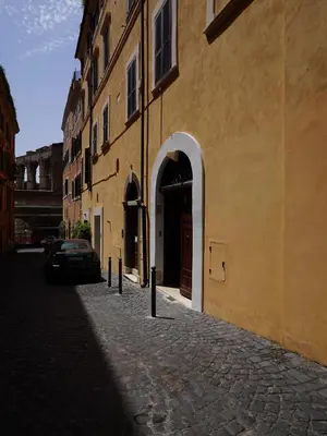 a building with a car parked next to a street at Tre Colonne in Rome