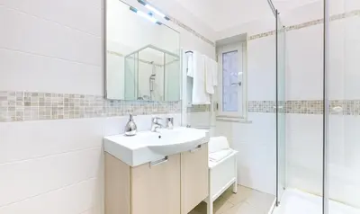 a white bathroom with a sink and a shower at PeoniaMaximaHouse -Piazza Bologna- in Rome