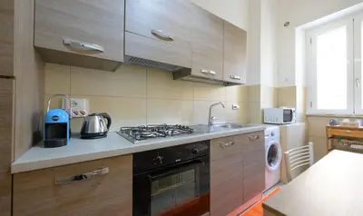 a kitchen with a stove and a sink and a dishwasher at PeoniaMaximaHouse -Piazza Bologna- in Rome
