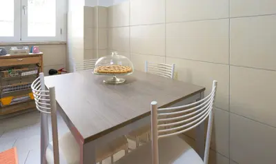 a dining room table with chairs and a bowl on it at PeoniaMaximaHouse -Piazza Bologna- in Rome