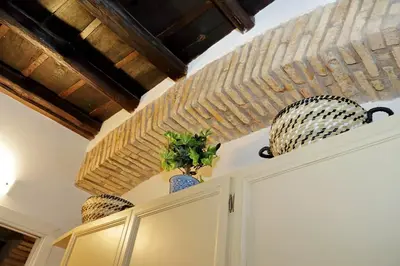 a kitchen cabinet with two vases on top of it at luxury home trastevere in Rome