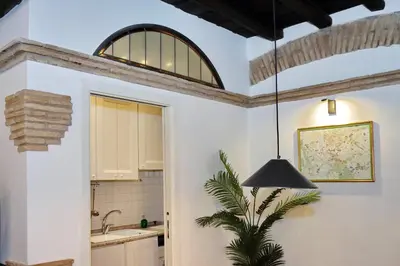 a kitchen with a pendant light hanging from a ceiling at luxury home trastevere in Rome