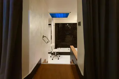 a bathroom with a tub and a sink and a blue light at Cloe Suite - A due passi da Villa Borghese in Rome