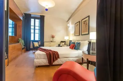 a hotel room with a bed and a table at Cloe Suite - A due passi da Villa Borghese in Rome