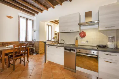 a kitchen with a table and a dining room at Happy Trastevere in Rome in Rome