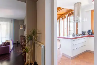 a kitchen and living room with white cabinets at Aurelia - Roof Garden close to Vatican in Rome
