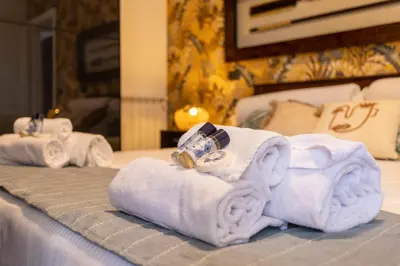a pile of towels and rings on a bed at Aurelia - Roof Garden close to Vatican in Rome