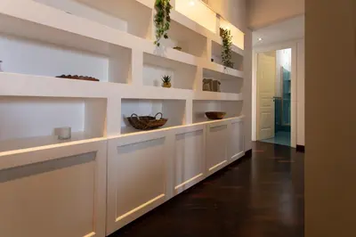 a hallway with white shelves in a house at Aurelia - Roof Garden close to Vatican in Rome