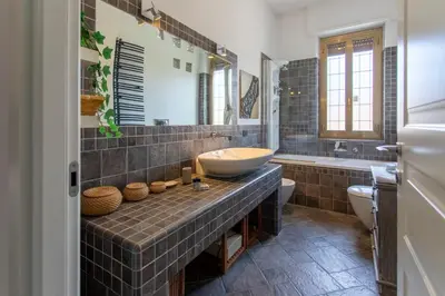 a bathroom with a sink and a toilet and a tub at Aurelia - Roof Garden close to Vatican in Rome