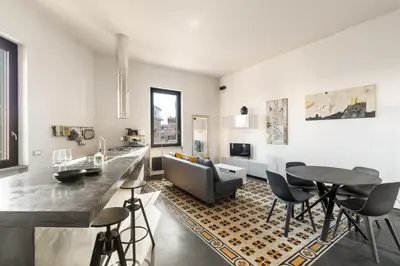 a kitchen and living room with a table and chairs at Fantastic Penthouse over the Roman Sky in Rome