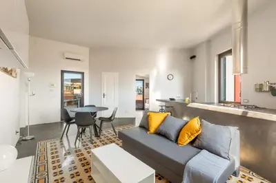 a living room with a couch and a table at Fantastic Penthouse over the Roman Sky in Rome