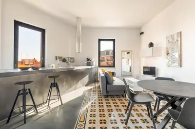 a kitchen and living room with a table and chairs at Fantastic Penthouse over the Roman Sky in Rome